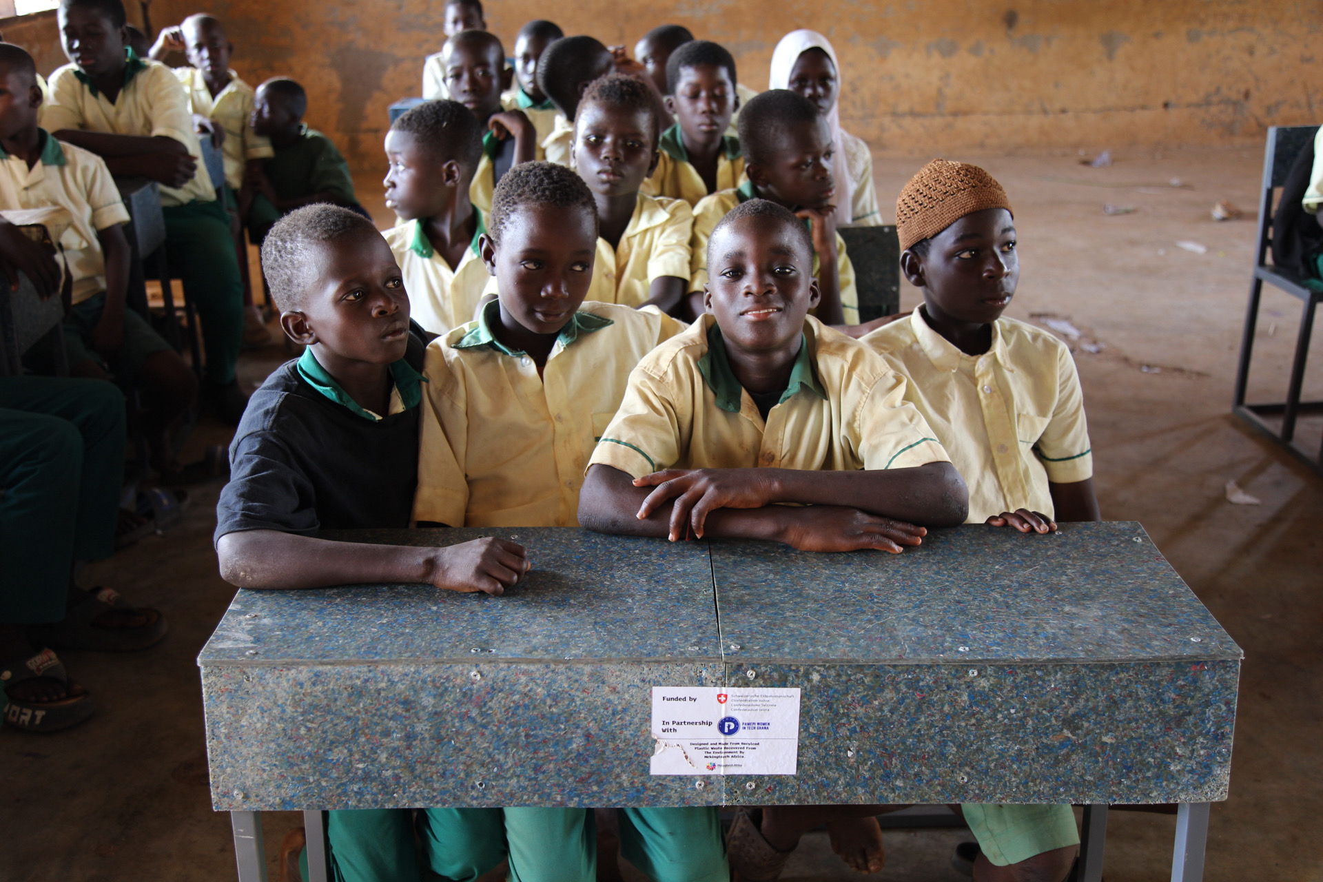 Close-up of a recycled plastic desk with a partnership sticker, produced by McIntorch Africa